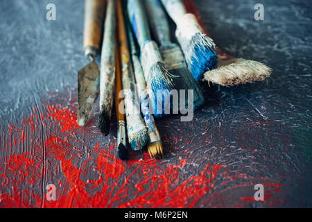 A set of brushes on a colorful colorful background with red blots Stock Photo
