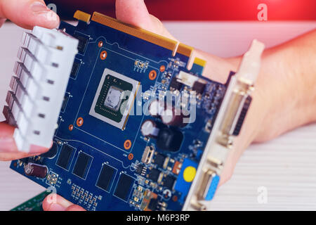 Man sets up a farm on video cards for bitcoin mining Extraction of crypto currency from video cards Stock Photo