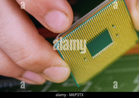 Computer technician installing CPU into motherboard. Close up. installed in PC motherboard. Stock Photo