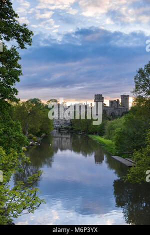 Warwick castle at sunset in Spring with the river Avon flowing past it, Warwick, Warwickshire Stock Photo