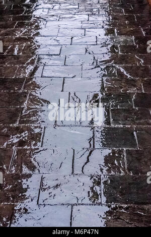 A reflection of light on a wet pavement in Madrid during a rainy day. Stock Photo