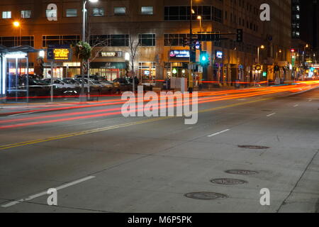 Minneapolis Minnesota - November 2016: Light trails from cars at night traveling through downtown MN past the financial district and restaurant row.