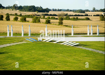 The royal seat of first kings of Denmark with large stone ship, two large burial mounds, the Jelling stones of Viking Age and Romanesque Jelling Churc Stock Photo