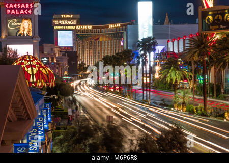 Las Vegas, USA - Circa 2017: Long exposure light trail of busy street night Las Vegas Blvd strip Traffic pass famous hotel casino resorts lit neon lig Stock Photo