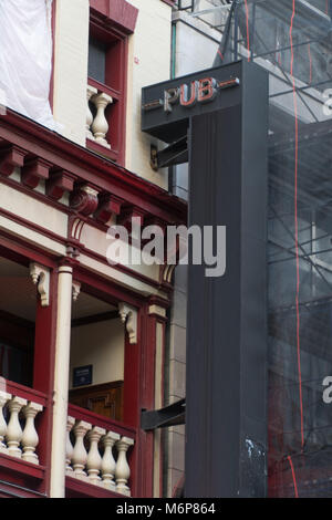 Generic pub sign on building tavern exterior to graphic overlay any name. Outside establishing shot of New Orleans New York city style building Stock Photo