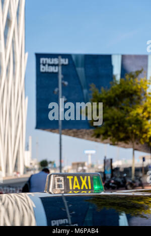Barcelona, Spain - September 24, 2017: The skyscraper Diagonal Zero Zero and the Blue Museum of Natural Sciences (Museu Blau) are being reflected in the metal roof of a taxi. Both buildings are imprtant architectural landmarks in Barcelona. Stock Photo