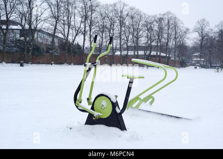 Exercise Equipment  in a public park covered in snow,UK. Stock Photo