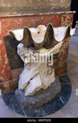 Church of Saint-Sulpice Benitier de droite by Jean-Baptiste Pigalle - A holy-water basin made from a giant clam shell.  The giant clam shells were pre Stock Photo