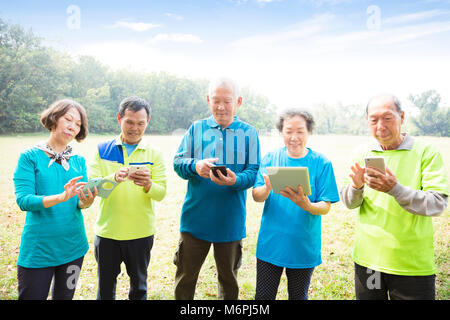 Group of seniors using smart phone Stock Photo