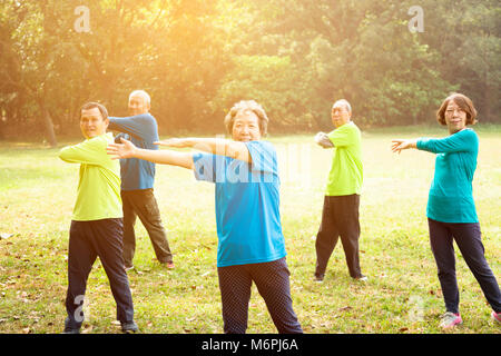 happy Senior Group Friends Exercise in the park Stock Photo