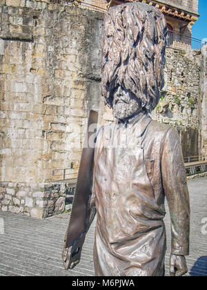 HONDARRIBIA, SPAIN-FEBRUARY 15, 2018: Bronze statue of bearded Hondarriban Soldier ('Hatxeroa') in bearskin hat with a saw Stock Photo