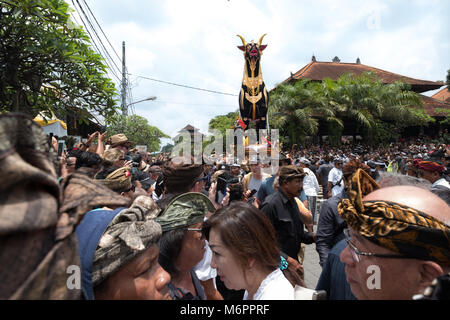 Crowds gather in front of the Saercophagus Bull in the streets of Ubud, Bali for the cremation of Anak Agung Niang Agung from the royal household. Stock Photo