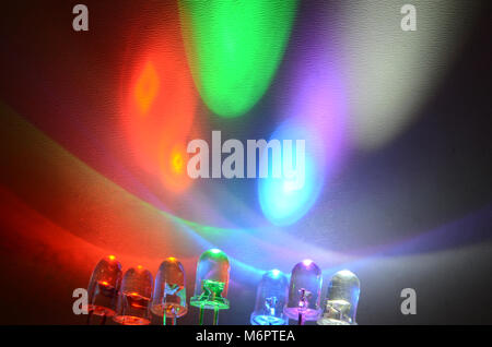 Row of  colored LEDs  in side view projects light on a white screen Stock Photo