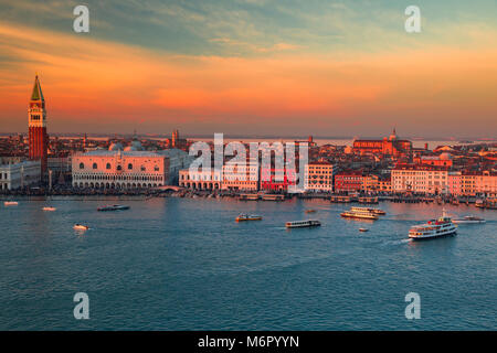 Aerial view of the city of Venice bathed in the winter sunset. View of the waterfront with palaces and tower churches. San Marco, Basilica Santa Maria Stock Photo