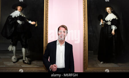 06 March 2018, Netherlands, Amsterdam: Taco Dibbits, director of the Rijksmuseum, standing in the exhibition 'High Society', which opens on 08 March 2018. Behind him hang protraits of Marten Soolmans and Oompje Coppit by Rembrandt van Rijn. Portraits of powerful princes, excentric aristocrats and rich burghers from different eras can be seen until 03 June 2018. Photo: Jeroen Jumelet/dpa - ATTENTION EDITORS: EDITORIAL USE ONLY IN CONNECTION WITH CURRENT REPORTING ON THE EXHIBITION. Stock Photo