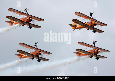 AeroSuperBatics Brietling Wingwalkers aerobatic formation wingwalking team perform flying display at Farnborough Airshow 2014 Stock Photo