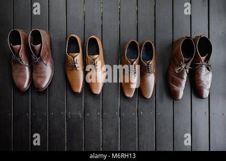 The brown shoes on the black wooden floor, Leather. Stock Photo