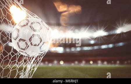 Soccer ball scores a goal on the net. 3D Rendering Stock Photo