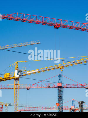 Many construction cranes on blue sky backgrounds. Construction Background Stock Photo