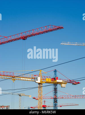 Many construction cranes on blue sky backgrounds. Construction Background Stock Photo