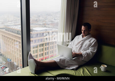 Young man freelancer working from home on a laptop. Stock Photo