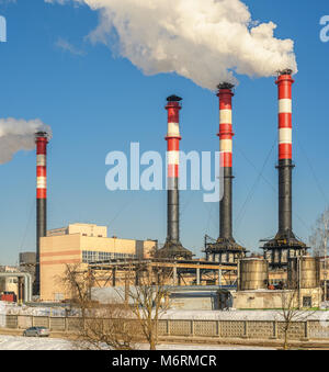 Thermal power plant during winter operation. High chimneys emit a large amount of smoke Stock Photo