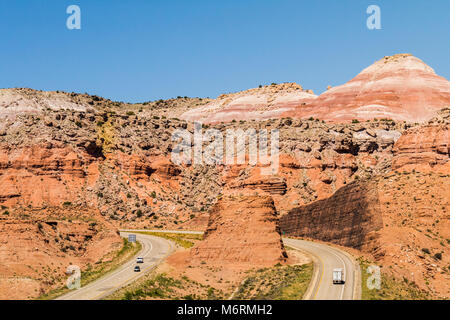 View of a highway in Utah; a rock huge rock formation serves as a median divider island;  USA Stock Photo