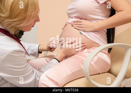 Examination of a pregnant woman by a doctor in hospital Stock Photo