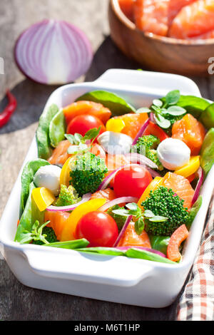 Tasty  fried and grilled salmon slices on mixed colorful vegetables and mozzarella Stock Photo