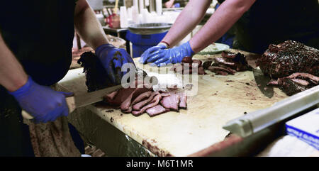 Meat smoking in open pit for bar-b-que Stock Photo