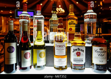 Modern alcohol beverage bar setup in low light. Stock Photo
