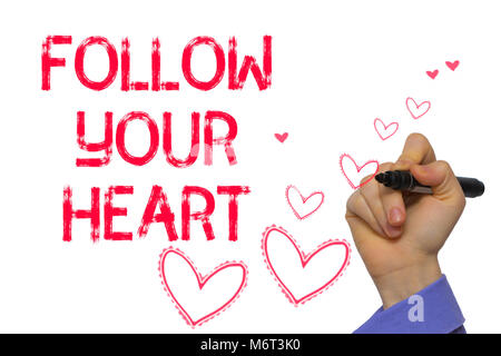 Hand with marker writing: Follow Your Heart.On a white background Stock Photo