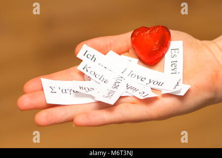 I Love You. The words, printed on papers in different languages on your palm Stock Photo