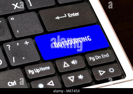 Business Concept - Blue Outsourcing Button on Slim. Stock Photo
