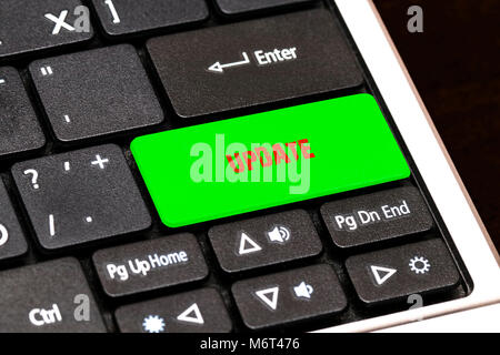 On the laptop keyboard the green button written UPDATE. Stock Photo