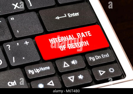 On the laptop keyboard the red button written Internal Rate of Return. Stock Photo