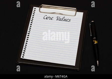 Top view of clipboard and white sheet written with Core Values on black background. Business Concept. Stock Photo