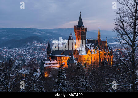 Wernigerode, Germany - February 6, 2018: Castle Wernigerode in winter with snow during dawn and view on the city of Wernigerode in Saksen-Anhalt. Stock Photo