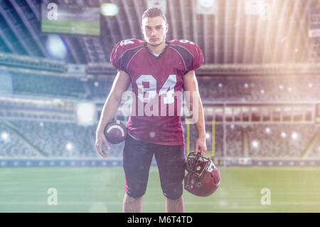 American Football Player isolated on big modern stadium field with lights and flares Stock Photo