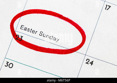 "Easter" is the text written on the calendar, circled in red marker. Stock Photo