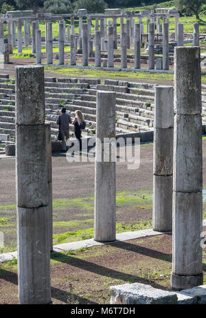 Visitors surveying the stadium surrouded by ancient  columns of the stoa, at Ancient Messene, Messinia, Peloponnese, Greece Stock Photo