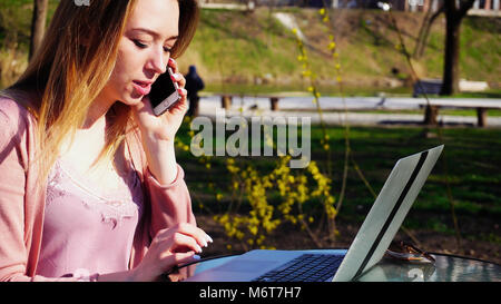 Pretty girl with close up face resting in spring park with table Stock Photo