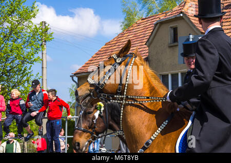 Sorbian easter riders (Osterreiter) and spectators attend the Easter procession in Radibor at Bautzen, Upper Lusatia, Saxony, Germany. Stock Photo