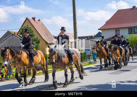 Sorbian easter riders (Osterreiter) and spectators attend the Easter procession in Radibor at Bautzen, Upper Lusatia, Saxony, Germany. Stock Photo