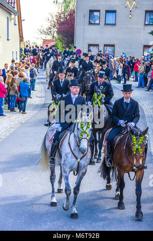 Sorbian easter riders (Osterreiter) and spectators attend the Easter procession in Radibor at Bautzen, Upper Lusatia, Saxony, Germany. Stock Photo