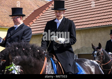 Sorbian easter riders (Osterreiter) and spectators attend the Easter procession in Radibor at Bautzen, Upper Lusatia, Saxony, Germany. Stock Photo