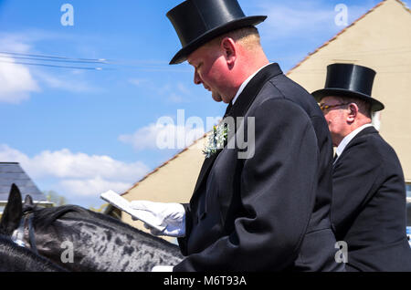 Sorbian easter riders (Osterreiter) and spectators attend the Easter procession in Radibor at Bautzen, Upper Lusatia, Saxony, Germany. Stock Photo