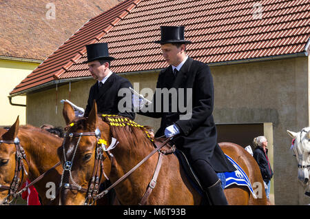 Sorbian easter riders (Osterreiter) and spectators attend the Easter procession in Radibor at Bautzen, Upper Lusatia, Saxony, Germany. Stock Photo