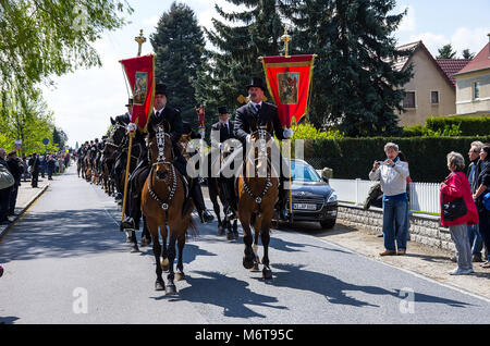 Sorbian Easter Riders (Osterreiter) and spectators attend the Easter procession in Radibor near Bautzen, Upper Lusatia, Germany. Stock Photo