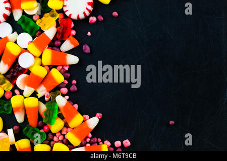 Colorful candies and  jelly on a black background background. Top view with copy space. Stock Photo